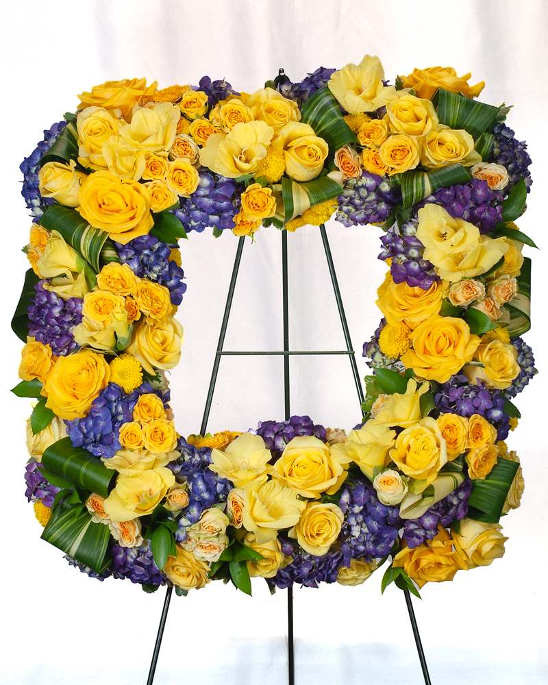 Yellow and purple floral wreath on a metal stand