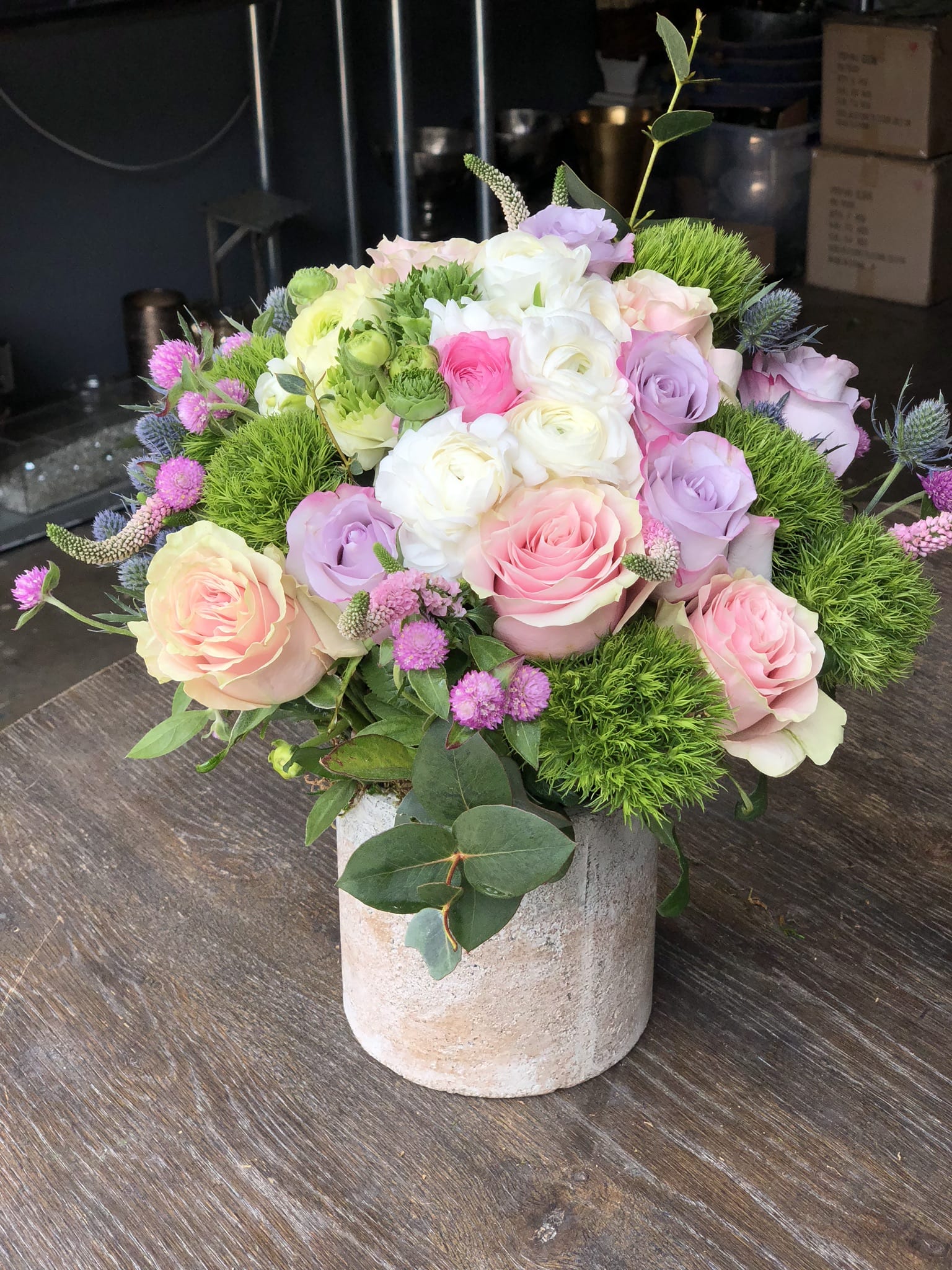 Pastel rose bouquet in a stone vase