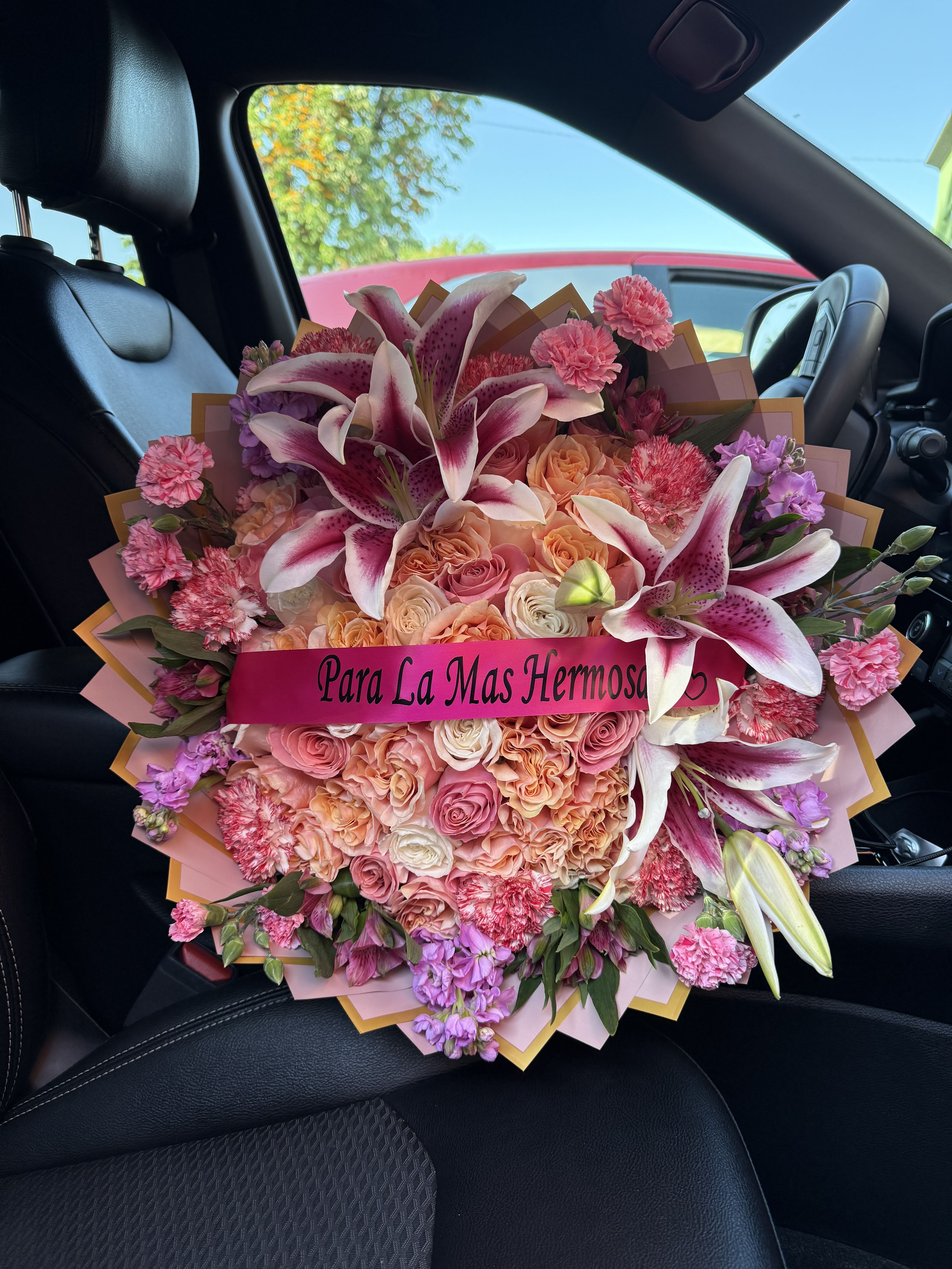 Large bouquet of pink and peach roses with lilies and carnations