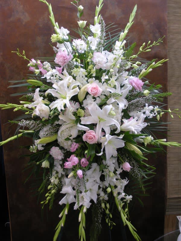 Large white and pink floral standing spray with lilies and roses