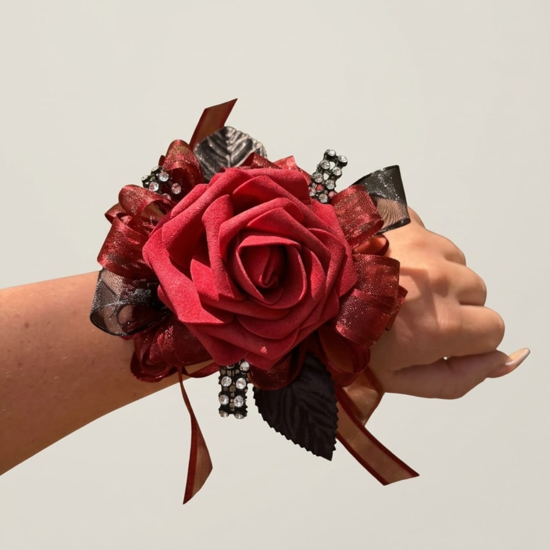 Red rose wrist corsage with ribbon and rhinestone accents