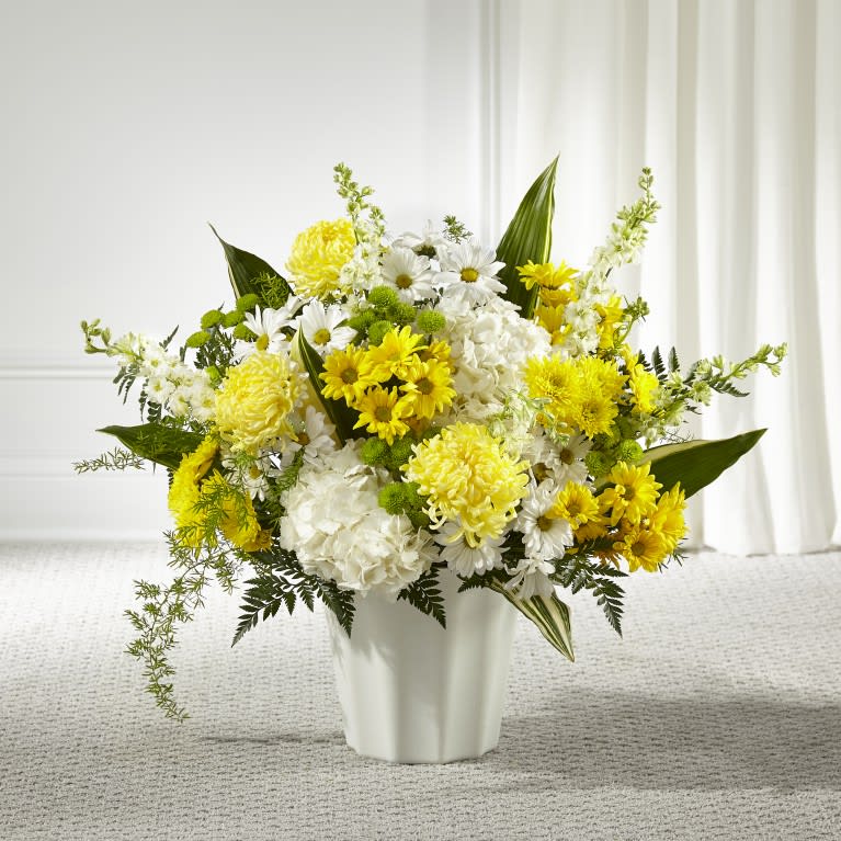 Yellow and white mixed bouquet in a white vase