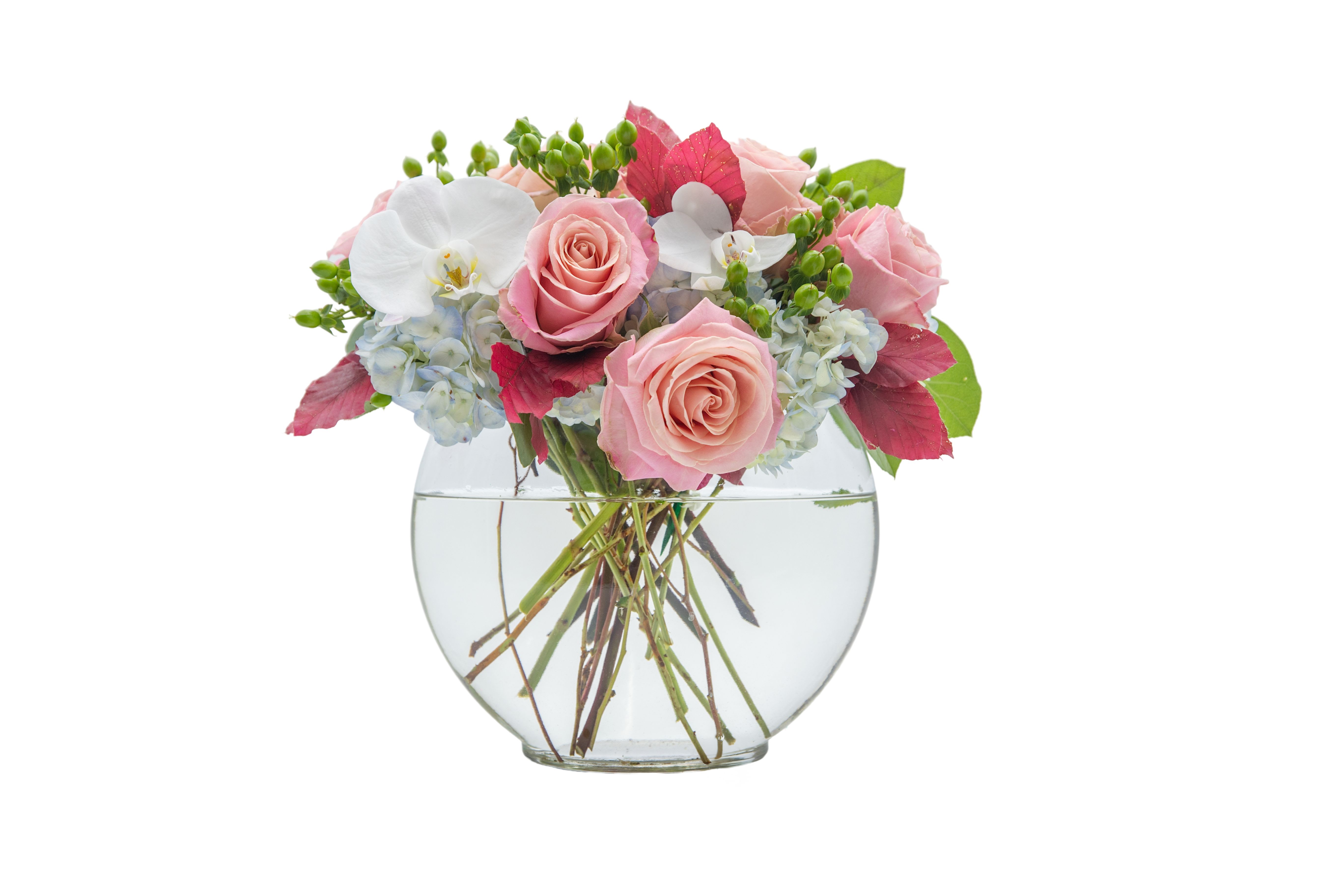Pink roses and white orchids in a clear glass vase
