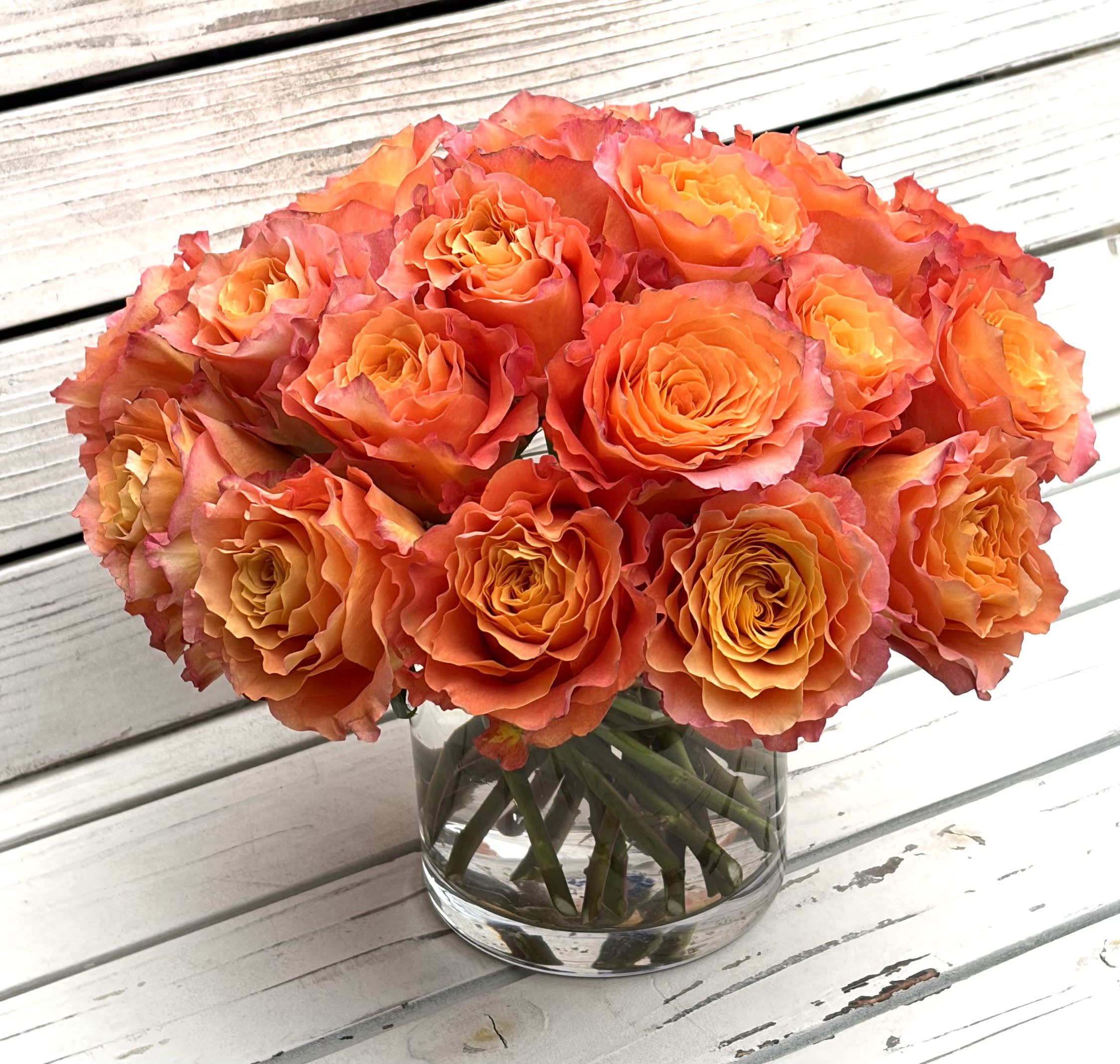 Spiral Free Spirit Rose Pavé Arrangement  - A spiral arrangement of 24 Free Spirit roses is perfect as a birthday bouquet, anniversary gift, or a spring celebration centerpiece.  The compact, pavé-like presentation gives a polished, classic silhouette that fits on a dining table or bedside dresser.