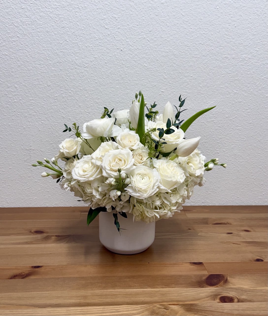 White floral arrangement in a white vase