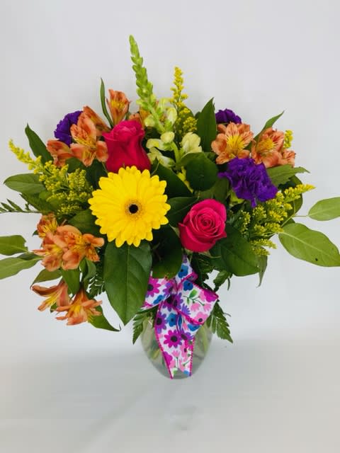 Mixed bouquet with roses, gerbera daisy, and alstroemeria in a glass vase