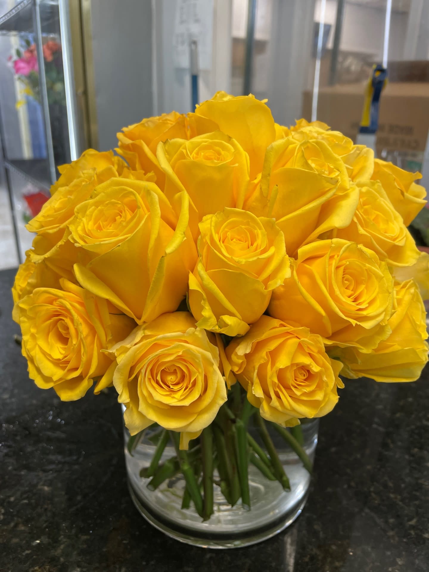Bouquet of yellow roses in a clear glass vase