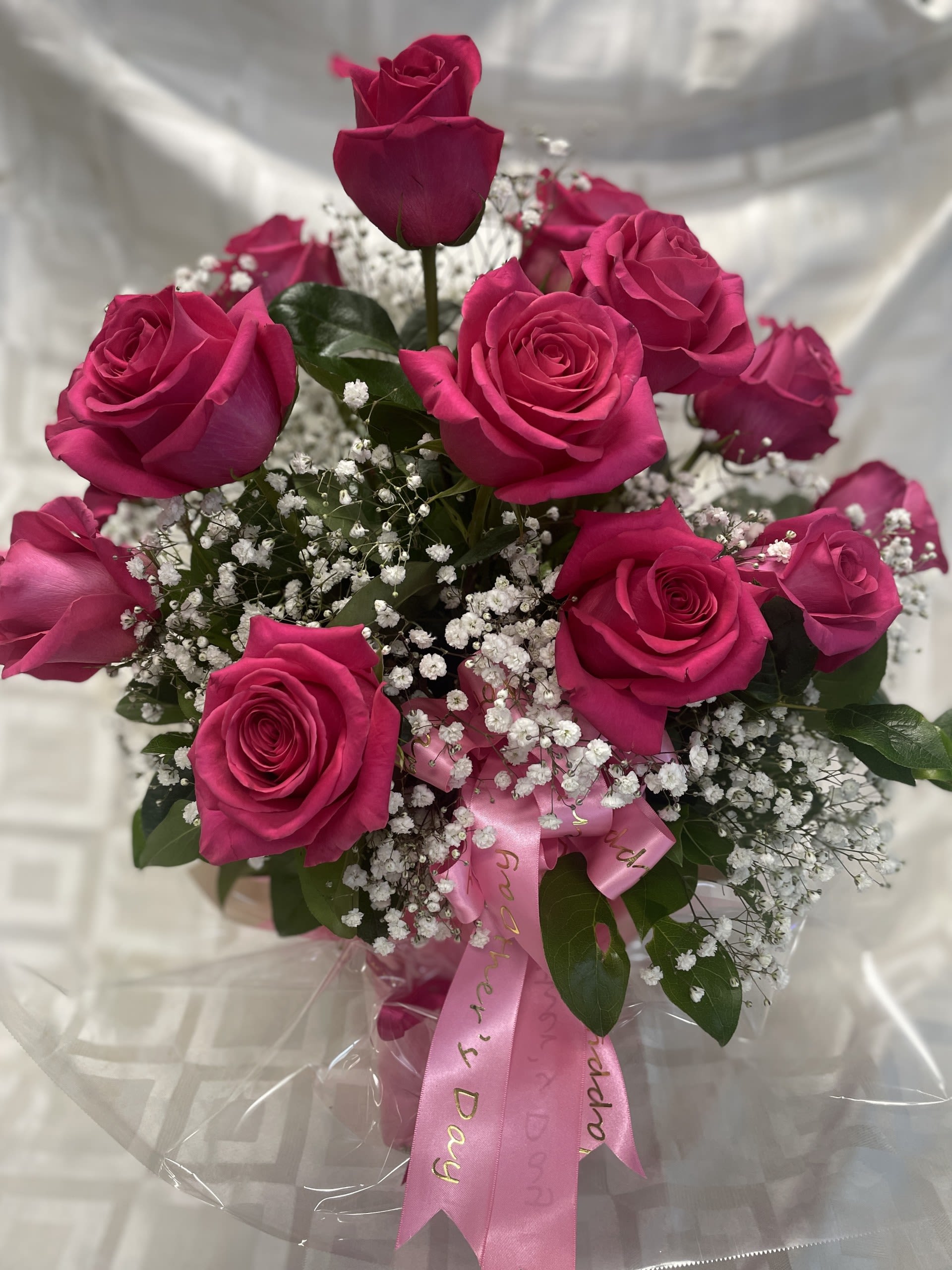 Bouquet of hot pink roses with baby's breath and a pink ribbon