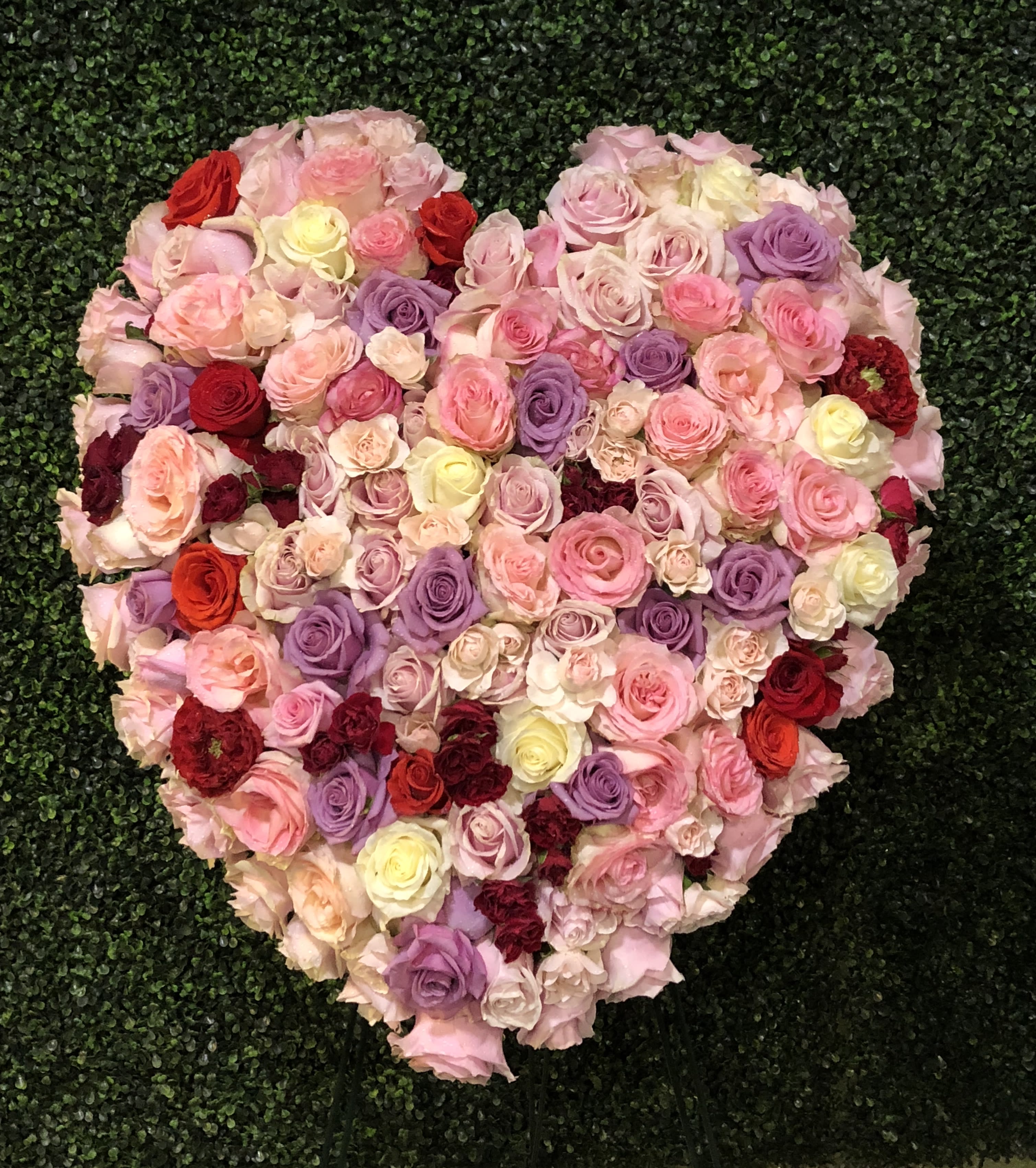 Loving Heart Standing Spray - The fragrant red, pink, white and lavender roses of this beautiful standing spray – created in the shape of a heart – will express your deepest love and devotion to all in attendance.