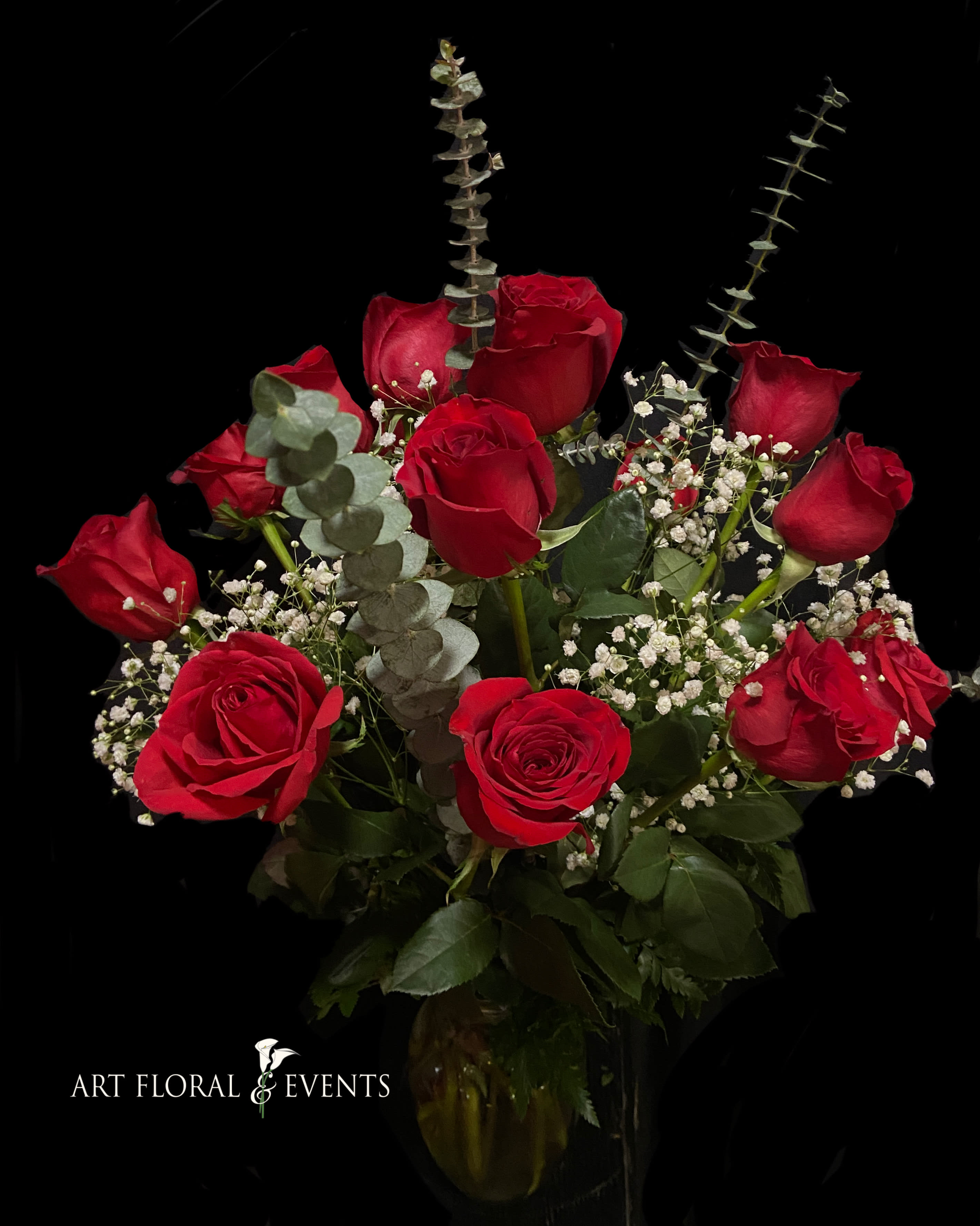 Bouquet of red roses with baby's breath and eucalyptus in a vase
