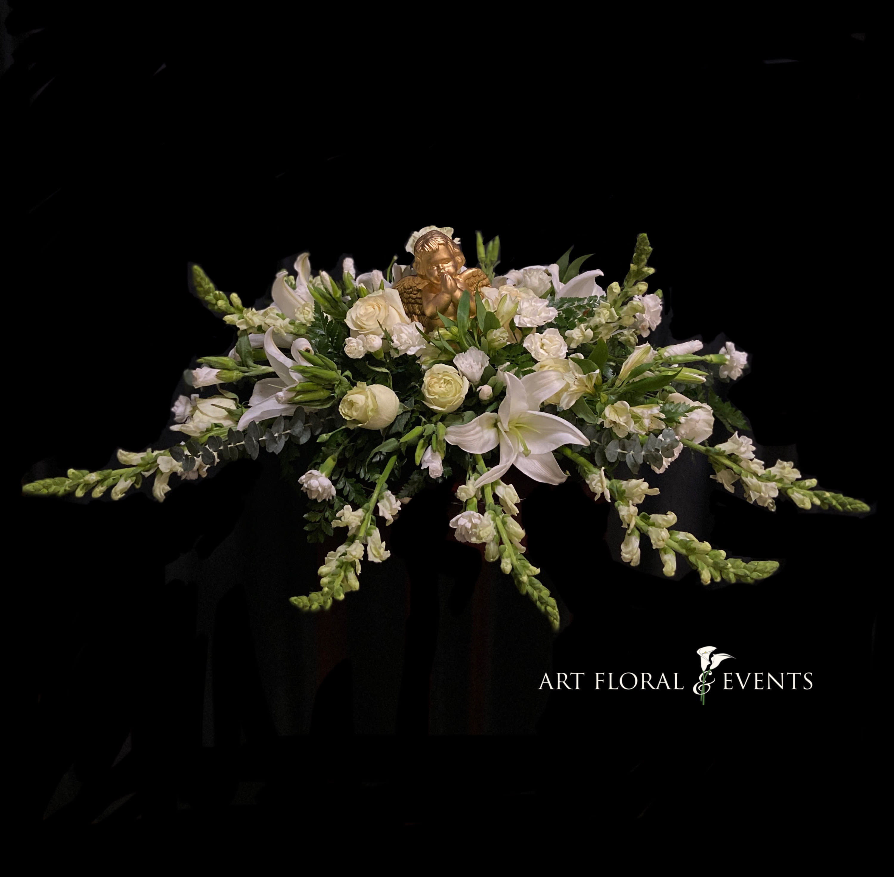 White floral casket spray with lilies and roses