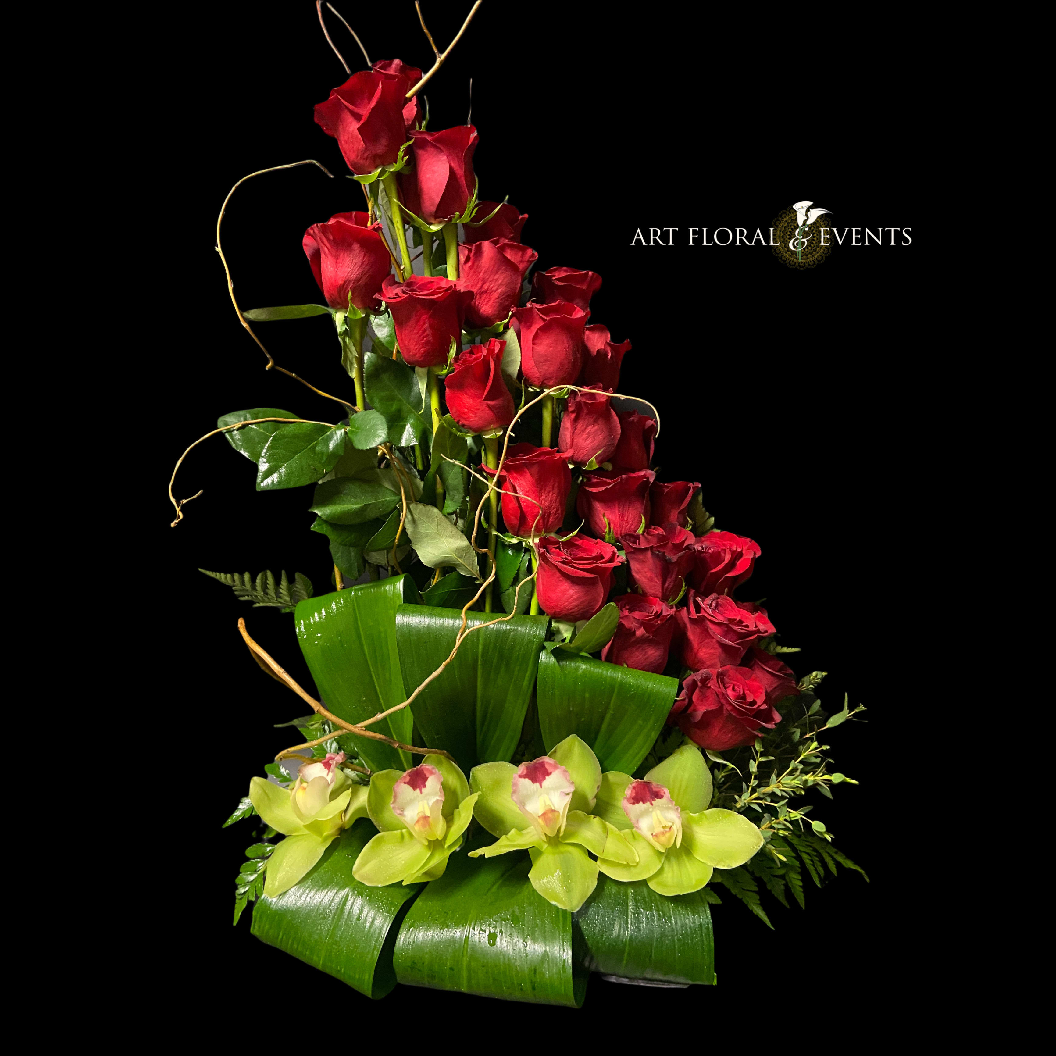 Tall arrangement of red roses with green orchids on a black background