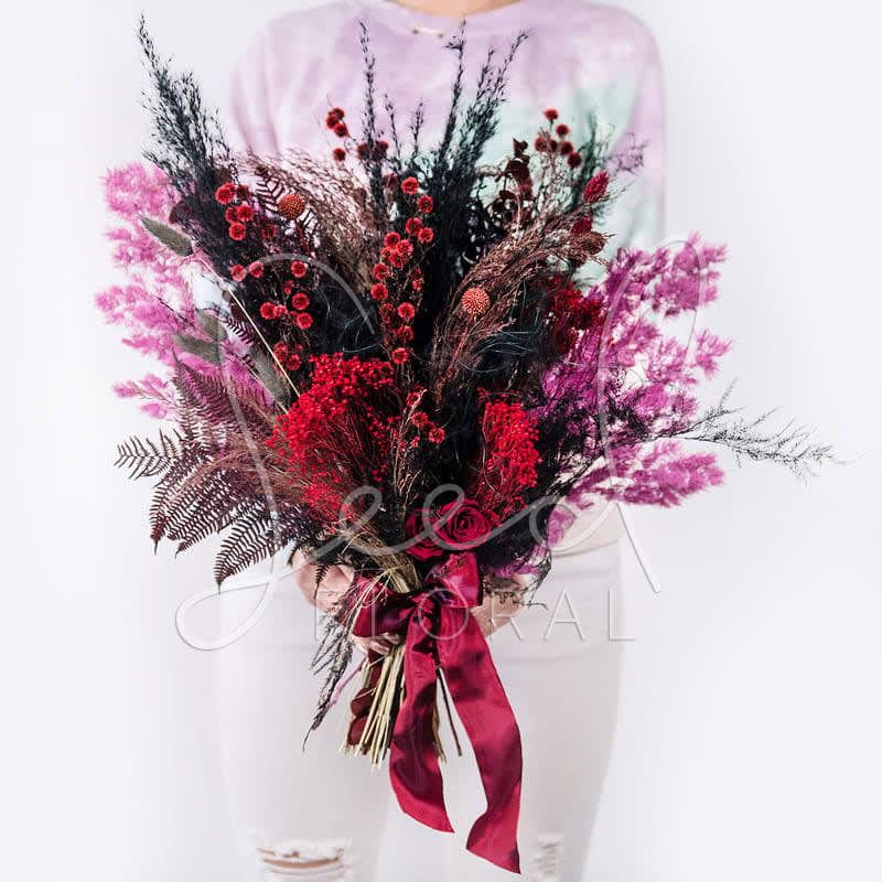 Large bouquet of red and pink flowers with a satin ribbon