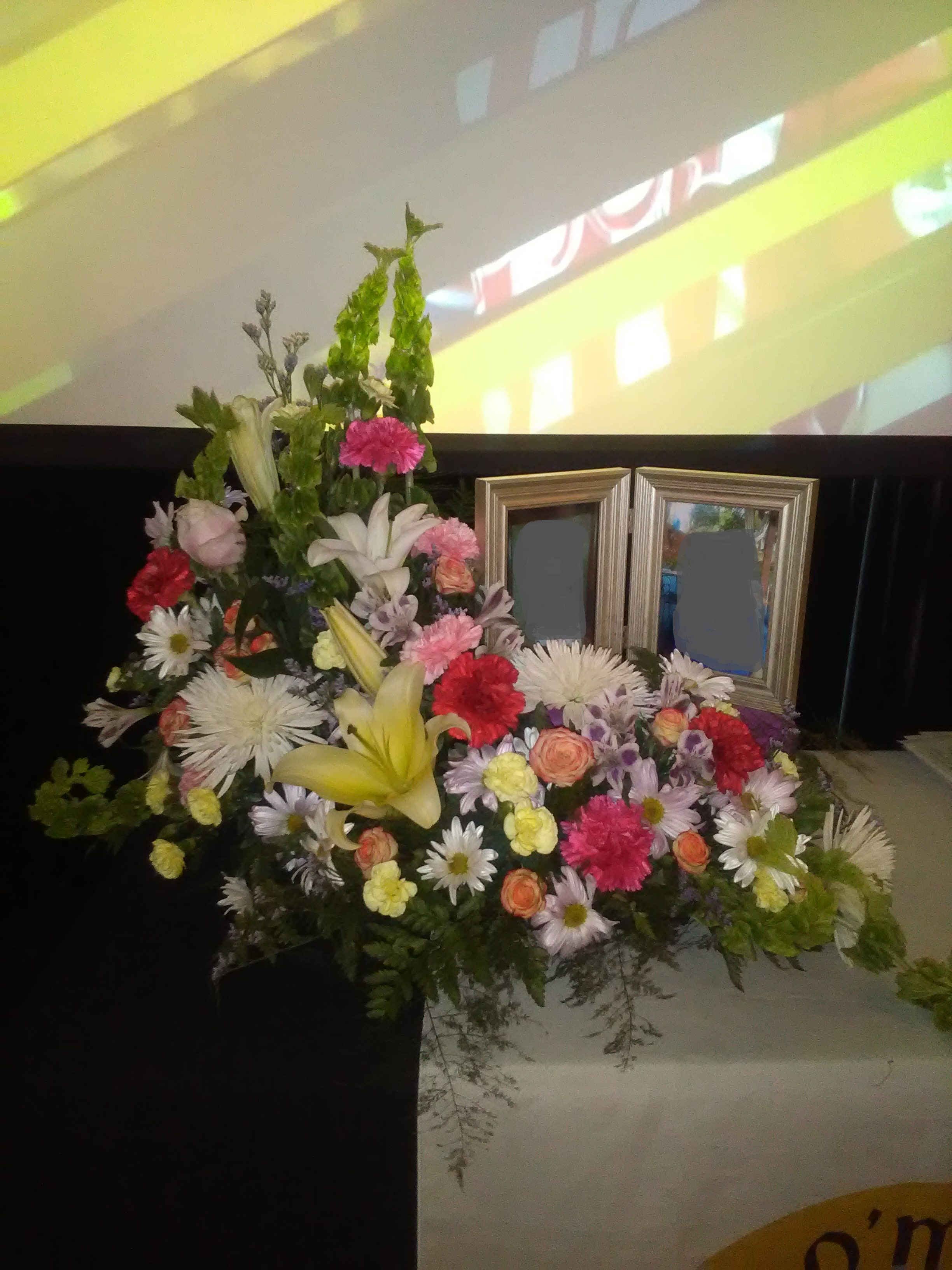 Large mixed floral arrangement with lilies, daisies, and carnations