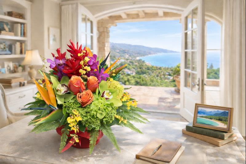 Tropical bouquet with orchids, roses, and bird-of-paradise in a red container