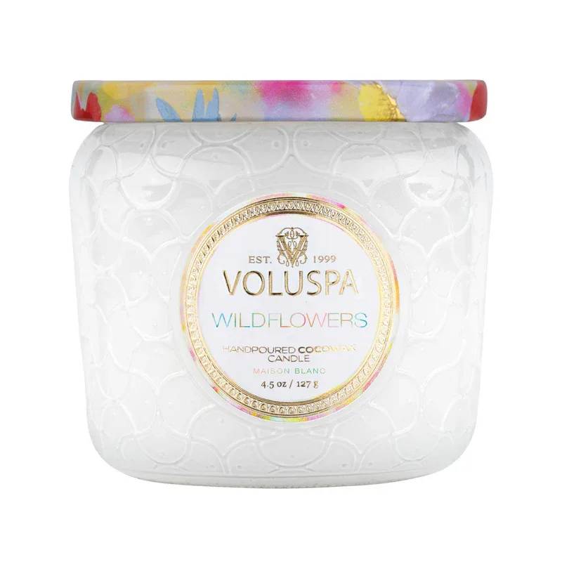 Voluspa Wildflowers Petite Jar Candle - You've been called to dance among the wildflowers, losing yourself in the beauty of this unruly floral sea. Lightly pass your hand over a kaleidoscope of Native Wildflowers, blooming Golden Poppy, Ambrosia and springing Herbs; sugared by misty vapors of Blue Agave and delicately kissed by the rising Citron sun. Gently coax this fragrant super bloom of Voluspa's Wildflowers.
