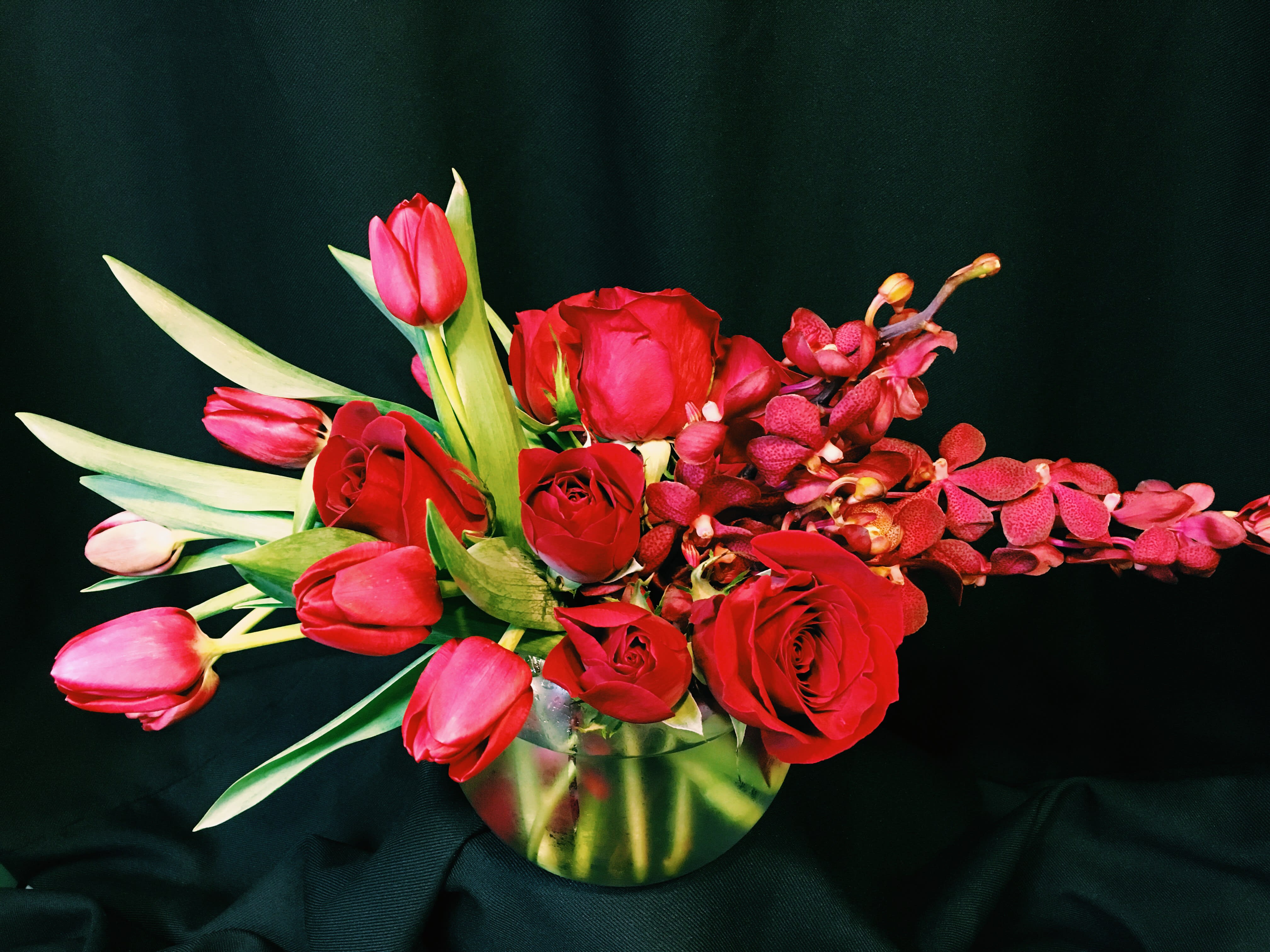 Orchid Rose Bowl - Red or Colored - Perfect Anniversary gift. Small bowl full of deep red roses, Rare Orchids &amp; Tulips. Provide at least a week's notice for us to acquire the orchids. Another color may need to be substituted.   Other colors available and may be substituted.  Add color requests to the Comments section.