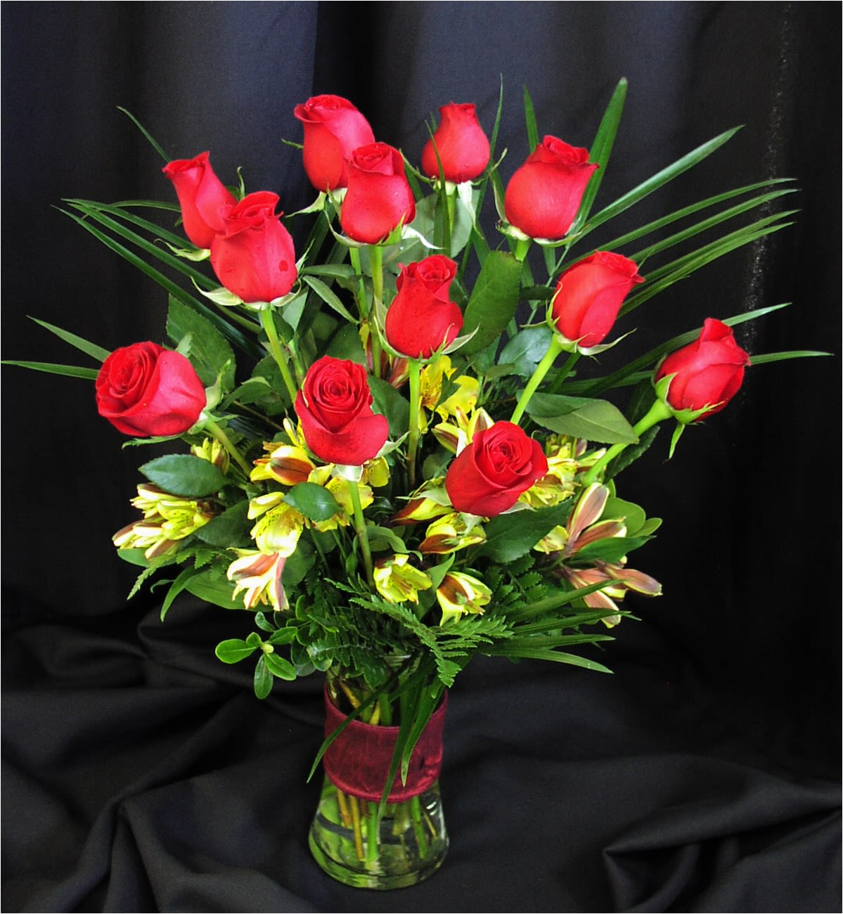 Dozen Medium Length Roses - RED or COLORED ROSES - Compare our premium medium stem roses to any other florist and you'll find ours are bigger, fresher and actually more affordable. Our medium dozen includes filler flowers, greenery, a ribbon clutch or bow, and quality vase. Rose color, Vase and accent flowers may vary.  Red Dozen unless  1) Red is unavailable  This happens at times, especially when less than 1 week advance notice (3 week notice Valentine's day) is given on your order &amp; we will notify you if this is the case or  2) You Choose Colored.  (Write Colored Roses in the Special Requests section. We cannot guarantee a specific color with online orders)  Includes filler flowers, greenery and vase. We deliver our roses completely arranged so there is no fuss to find scissors. All of this is included; there are no hidden costs for the best, most perfect roses you will find.