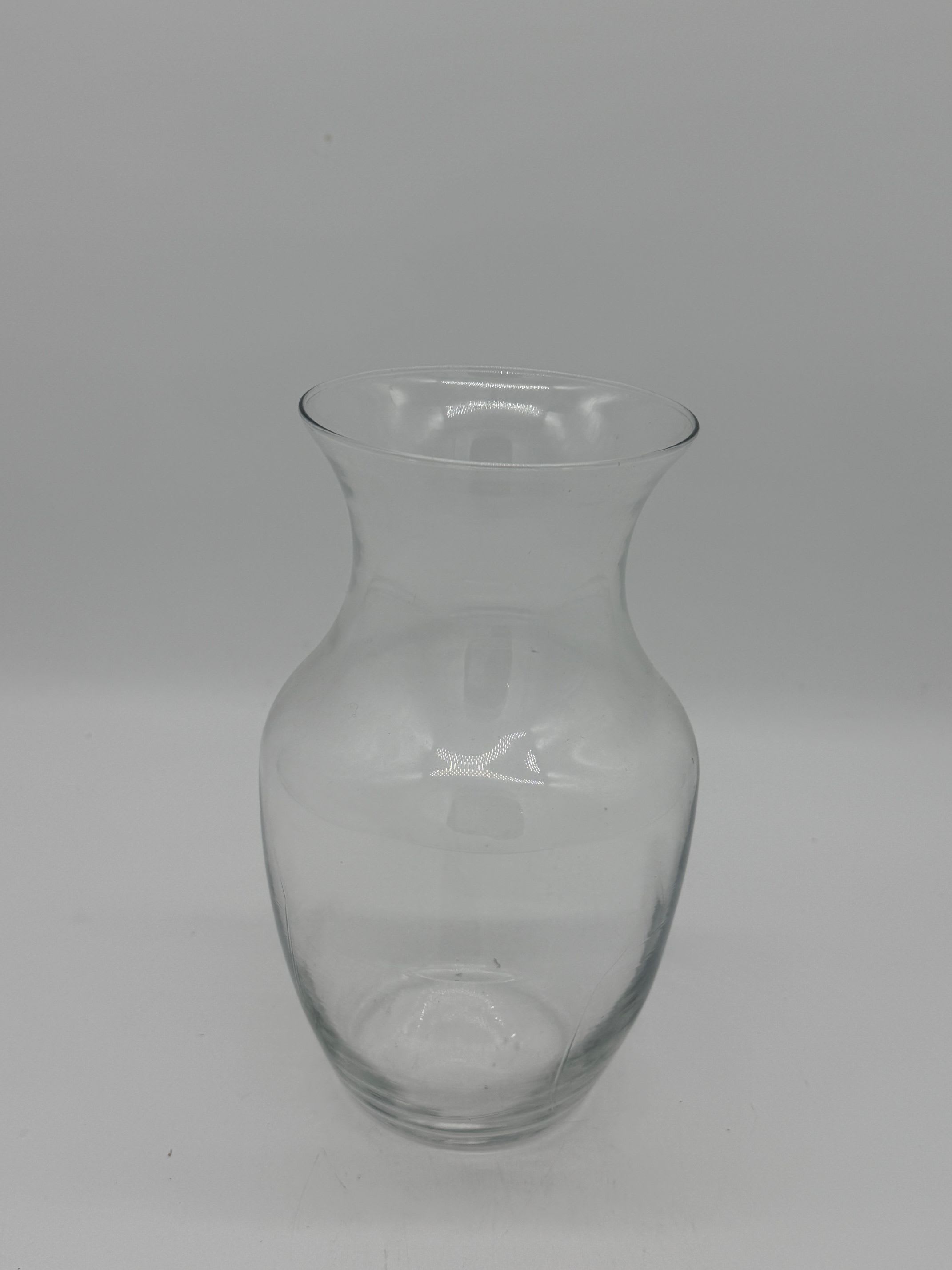 Clear glass vase with a flared rim and narrow neck