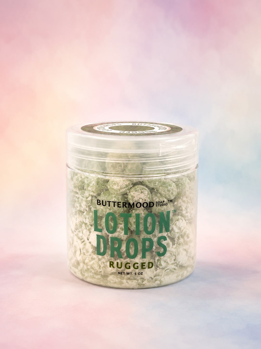 Jar of lotion drops with a pastel background