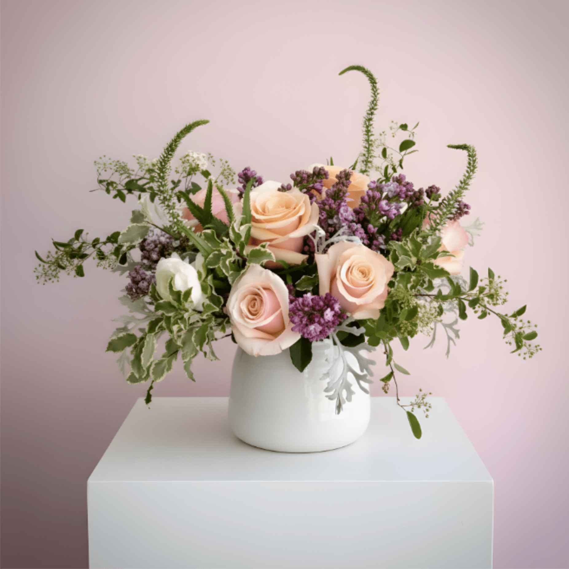 Peach roses and purple flowers in a white vase