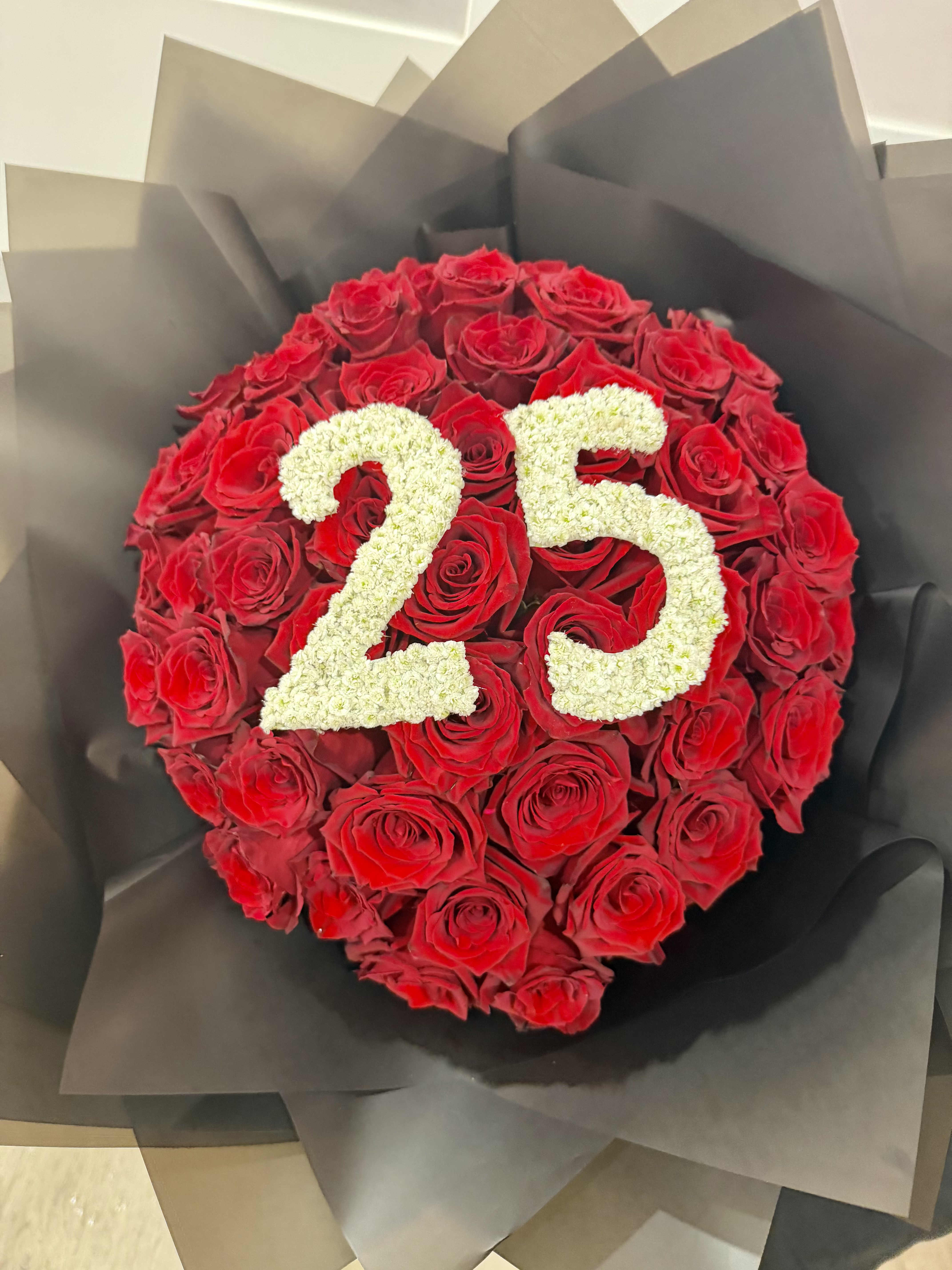 Numbers Rose Luxe Bouquet - Celebrate a milestone birthday in unforgettable style with this stunning handcrafted bouquet featuring premium long-stem roses arranged in a luxurious way. The custom white floral numbers gives this bouquet a unique and personalized touch, making it the perfect gift for birthdays, anniversaries, or special celebrations.  Wrapped in sophisticated premium paper with double satin ribbon accents, this arrangement delivers a modern and romantic presentation that leaves a lasting impression.  Details:  Premium fresh roses Custom floral number design Elegant &amp; luxe wrapping Hand-tied with satin ribbon Perfect for birthdays, anniversaries &amp; milestone celebrations  Style: Romantic • Luxury • Modern  - Rose Color can be customized upon request - Color wrapping can be customized upon request