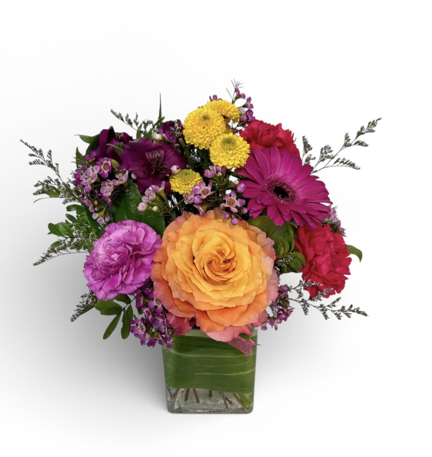 Colorful mixed bouquet in a square glass vase