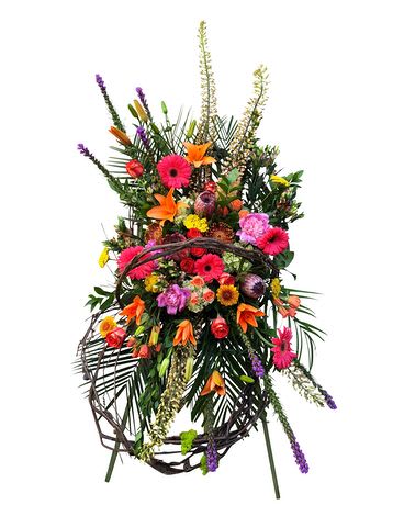 Tall colorful standing floral spray with mixed blooms on a wire easel