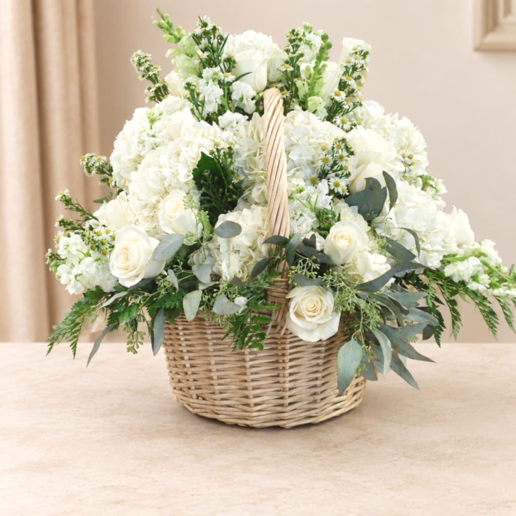 White floral basket arrangement with roses and hydrangeas
