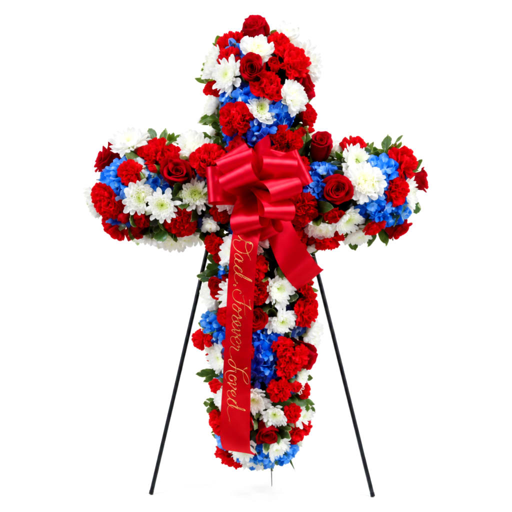 Cross-shaped floral standing spray with red, white, and blue flowers on an easel