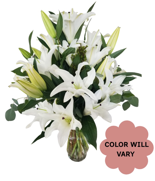 White lilies arranged in a clear glass vase