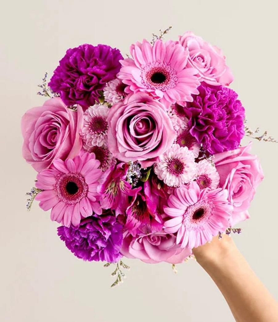 Pink and purple bouquet with roses, gerbera daisies, and carnations