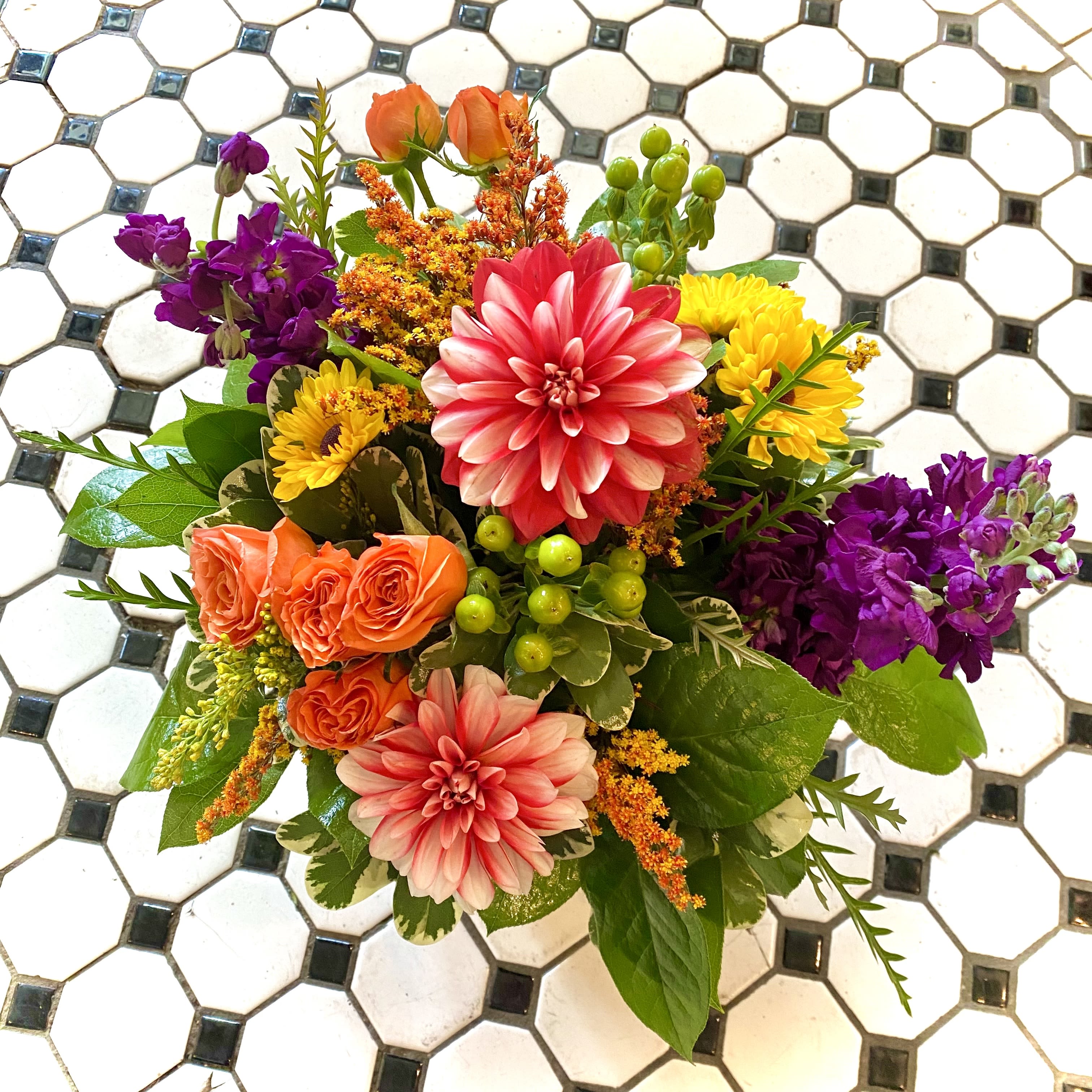 Colorful mixed bouquet with pink dahlias, orange roses, and purple blooms