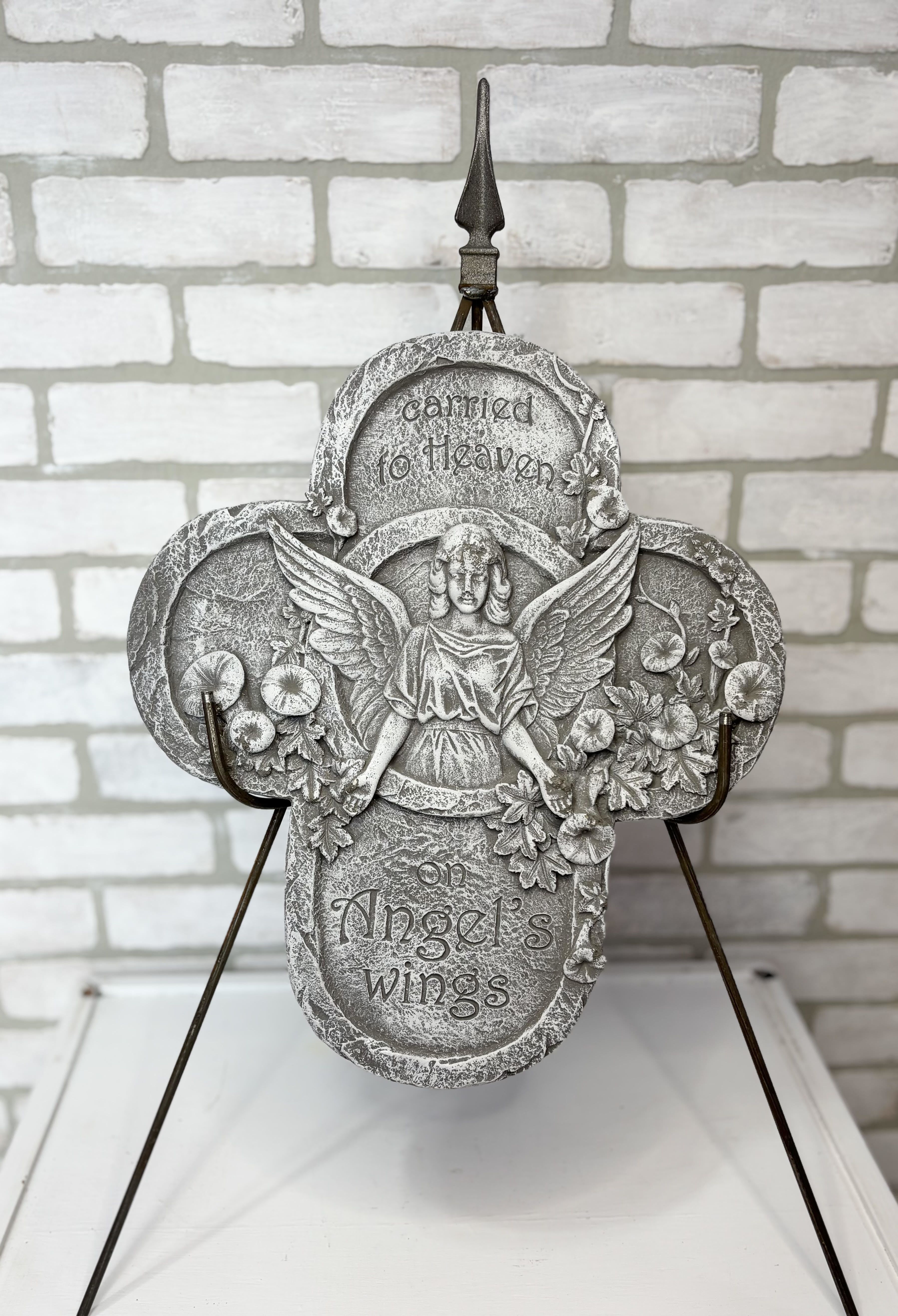 Decorative angel memorial plaque on a metal stand