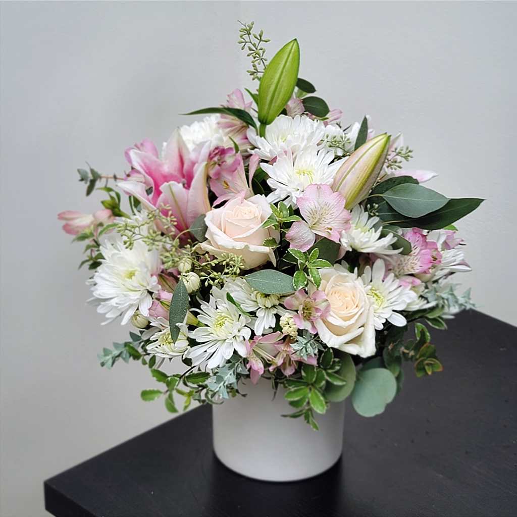 Eternal Affection - The Eternal Affection arrangement design is simple yet elegant, blending soft tones and delicate textures for a timeless, serene look.  Features: - White Chrysanthemums - Blush Pink Roses - Pink Oriental Lilies - Pale Pink Alstroemeria - Mixed Seasonal Greens - Arranged in a White Vase  Approximately 16" H x 16" W Elegant and calming, perfect for expressing quiet affection or sympathy.