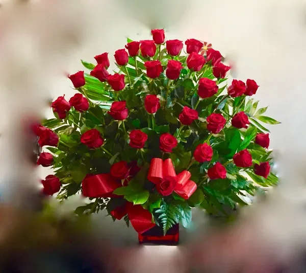 Large bouquet of red roses with a red ribbon bow