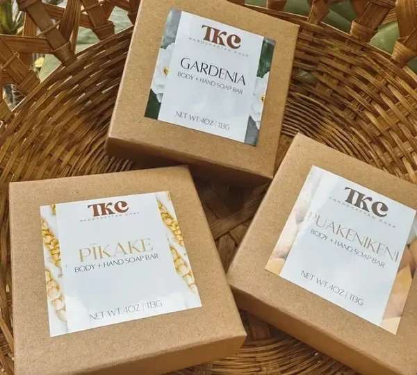 Three boxed body and hand soap bars in a wicker basket