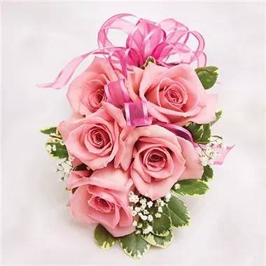 Rosita Corsage - The Rosita corsage is colorful and will be sure to make your prom date happy. It is made with pink spray roses, baby's breath flowers, and Pitt veragated and pink satin ribbon on a pearl bracelet.
