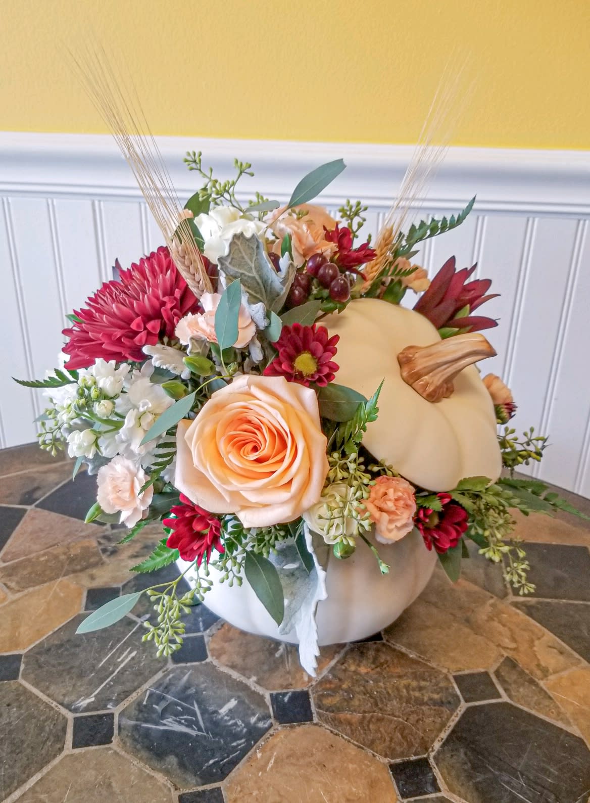 Winsome White Pumpkin  - A modern twist to a classic seasonal pumpkin.  A stunning white pumpkin filled with seasonal blooms makes for a gorgeous centerpiece. 