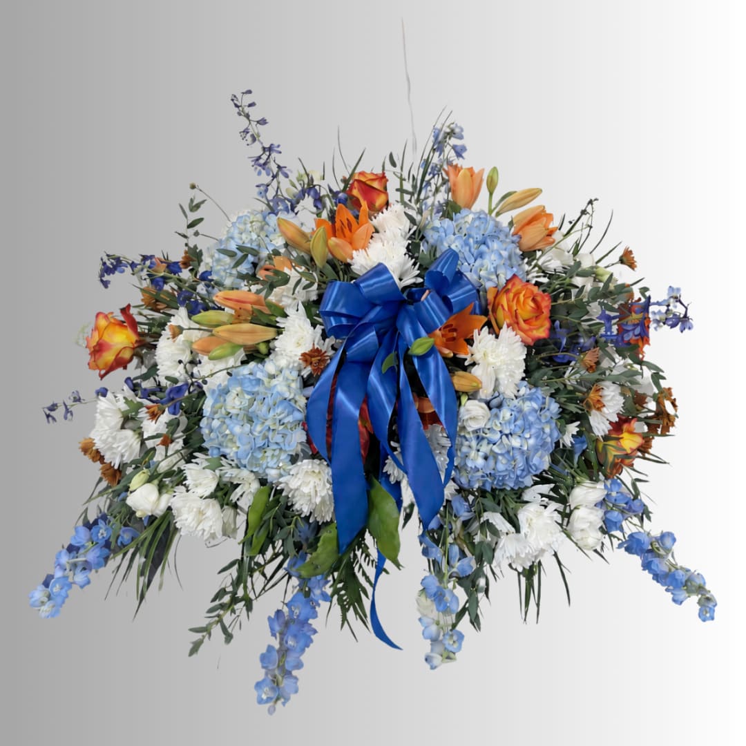 Large mixed bouquet with blue ribbon and blue, white, and orange flowers