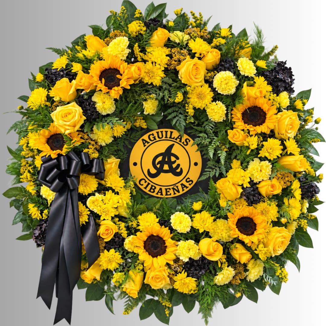 Yellow floral wreath with sunflowers, roses, and a black ribbon
