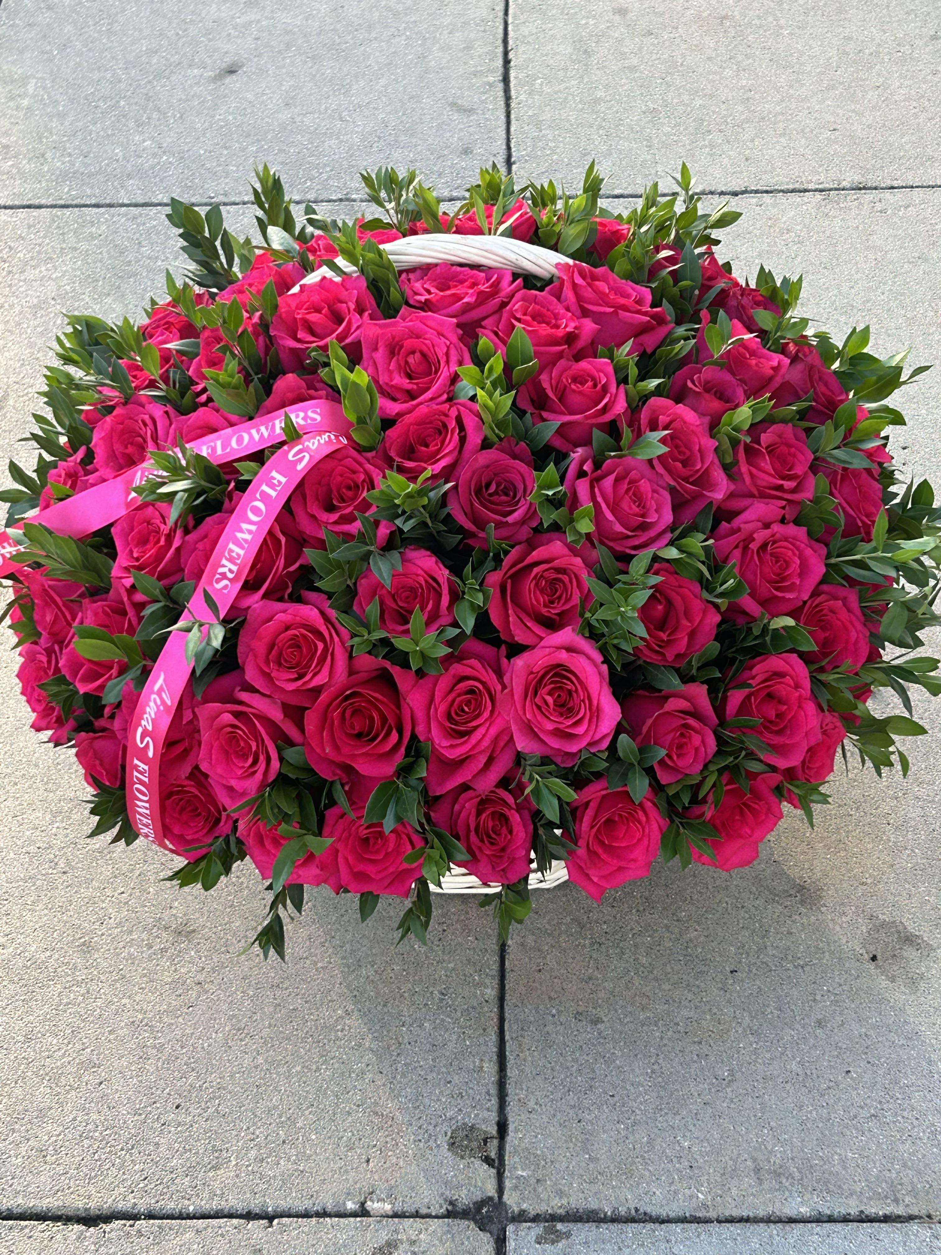 Large basket of hot pink roses with a pink ribbon