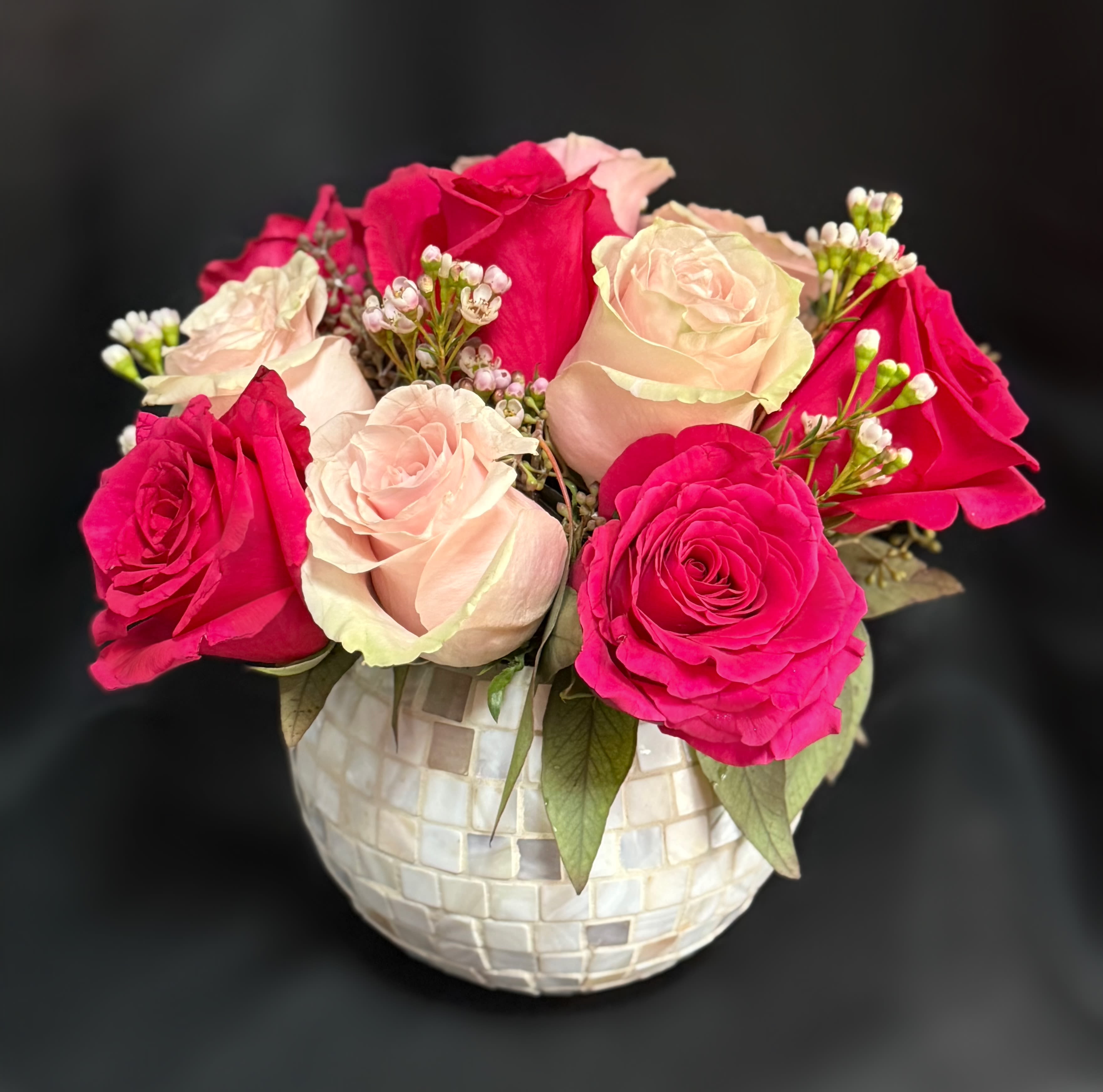 Pink and blush roses arranged in a mosaic vase