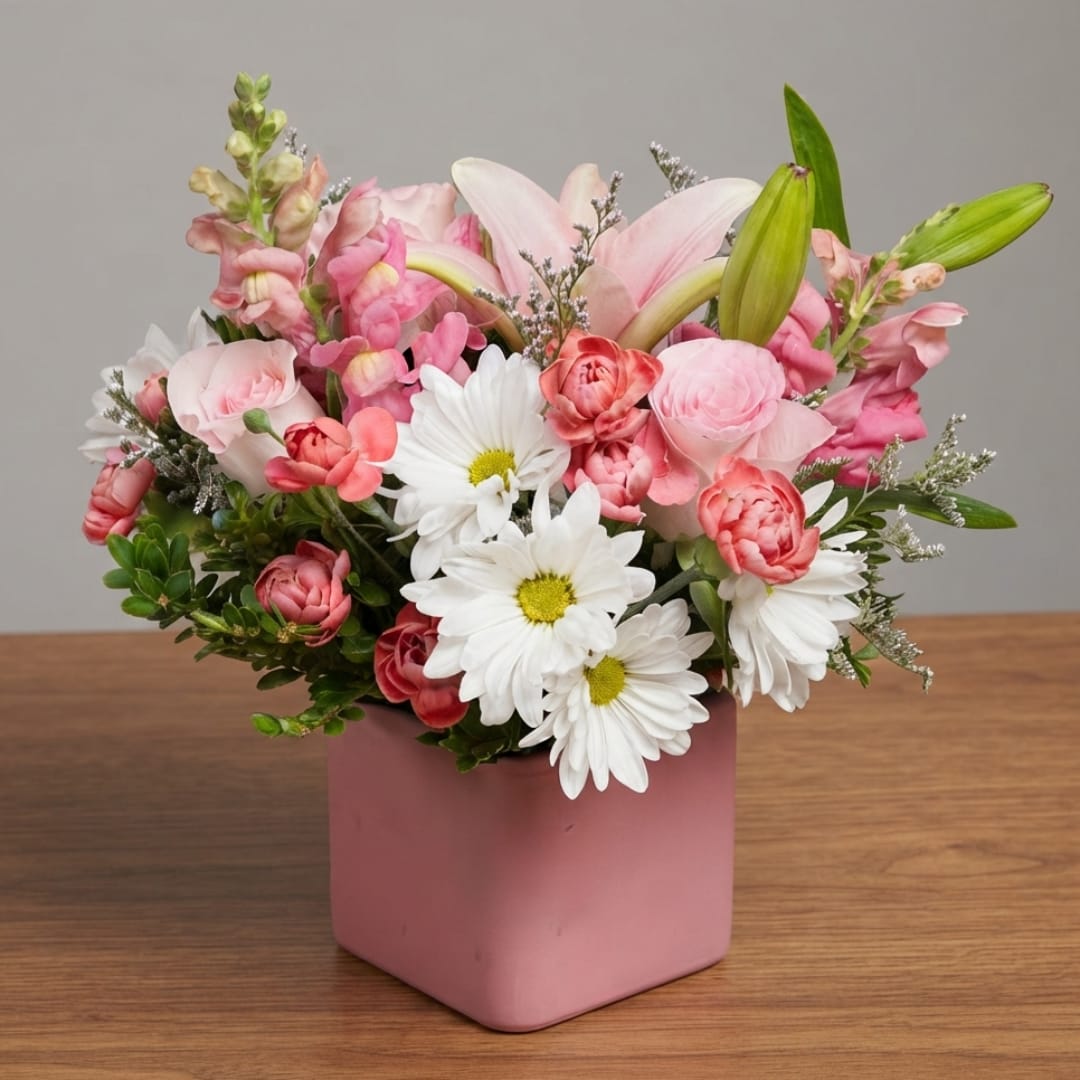 Pink and white mixed bouquet in a pink square vase