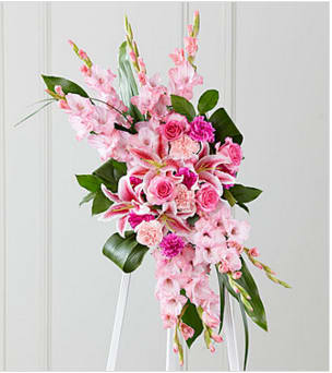 The FTD® Sweet Farewell™ Standing Spray - When your feelings of loss and sorrow compel you to make a grand gesture of sympathy, this dramatic, standing arrangement is a lovely way to convey your sincerest condolences. This extraordinary composition of pink blooms and lush greens handcrafted by an FTD artisan florist includes roses, carnations, gladiolus and Stargazer lilies set among lush, contrasting greenery. Made to be displayed on an easel, it makes an appropriate choice for a wake, funeral or graveside service, sure to be much appreciated and long remembered.  Your purchase includes a complimentary personalized gift message.