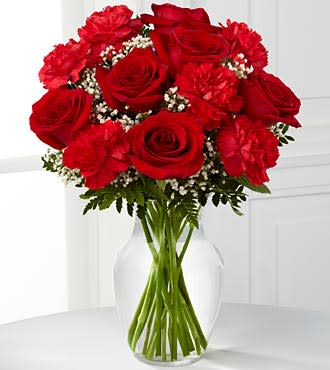 The Sweet Perfection Bouquet - The Sweet Perfection Bouquet by is an eye-catching way to capture their attention. Rich red roses and carnations are beautifully set amongst baby's breath and lush greens in a classic clear glass vase to create a sweet sentiment of love and affection.