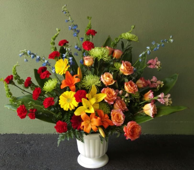 Colorful mixed flower arrangement in a white vase