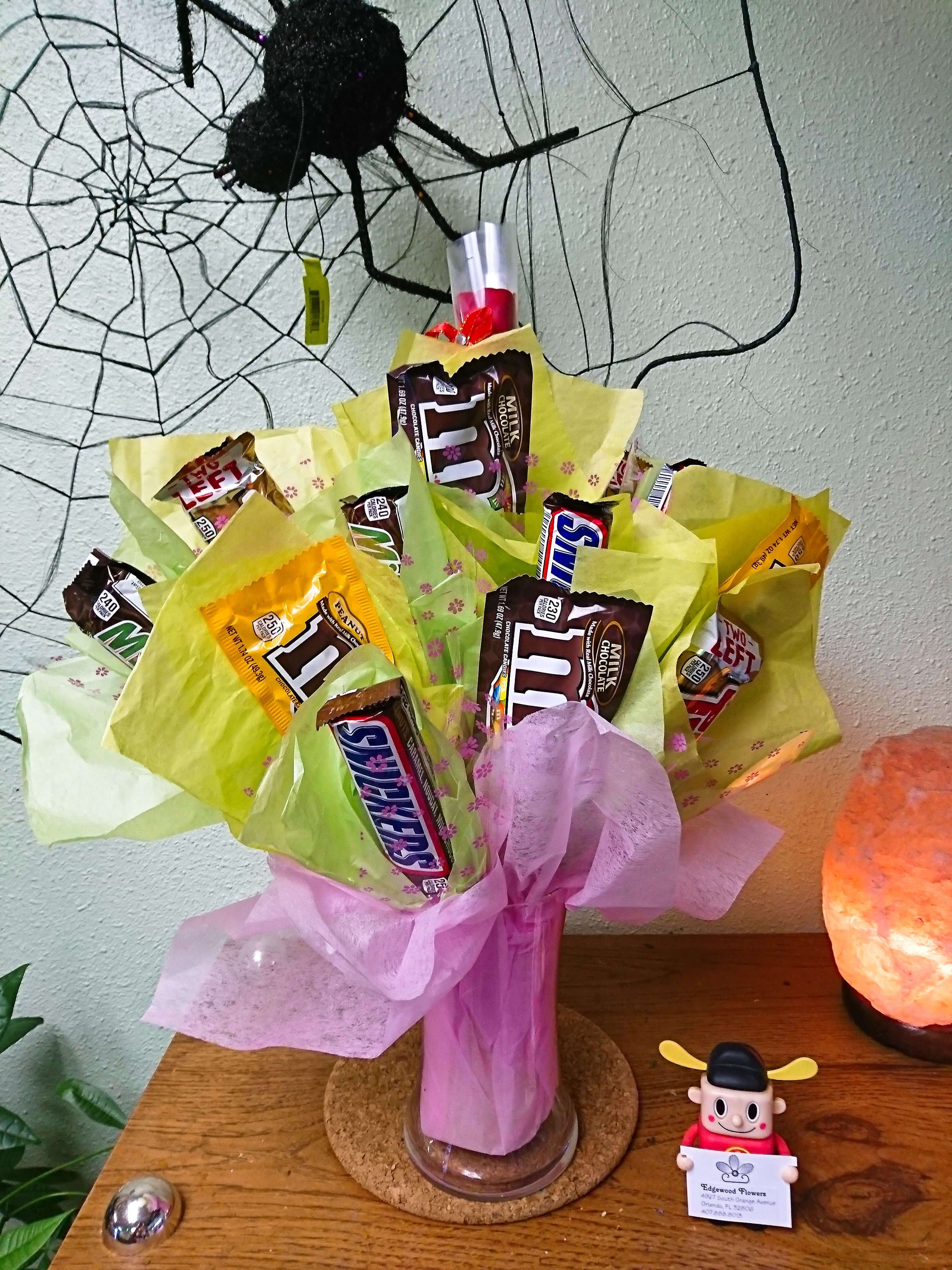 Bouquet of candy bars wrapped in pink and yellow tissue paper
