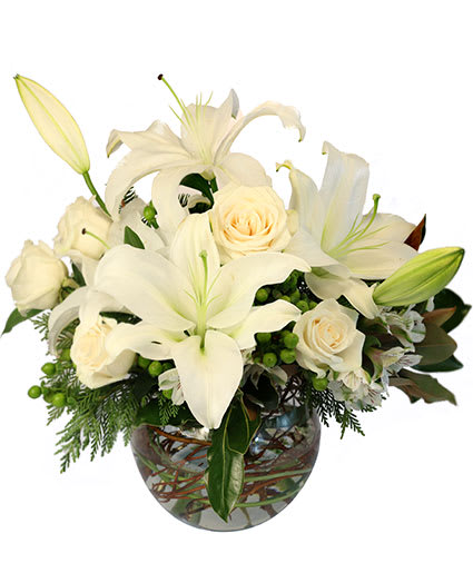 White lilies and roses arranged in a glass vase