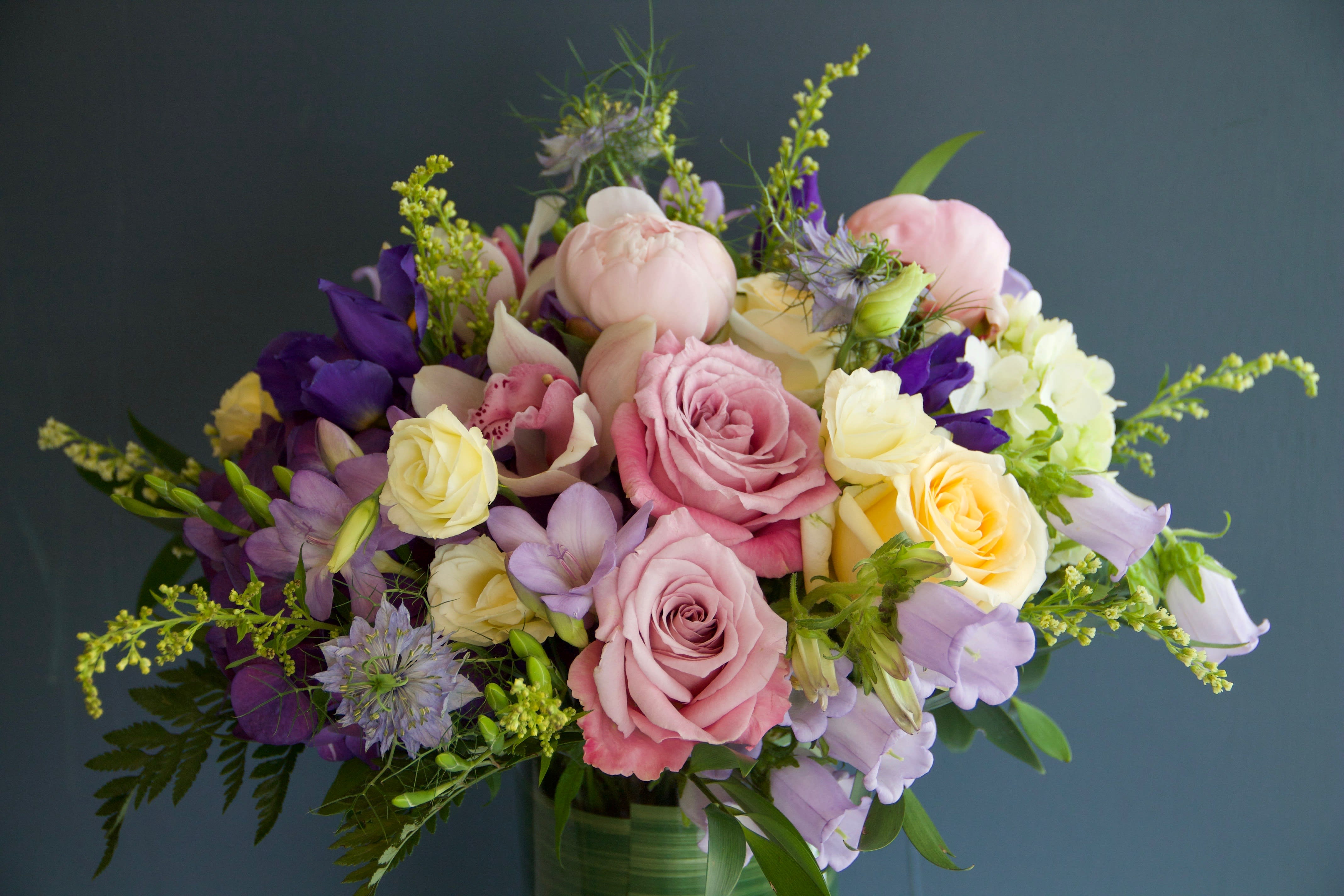 Bouquet of pink, yellow, and purple flowers in a glass vase
